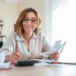 A woman access asset finance for her small business on a laptop